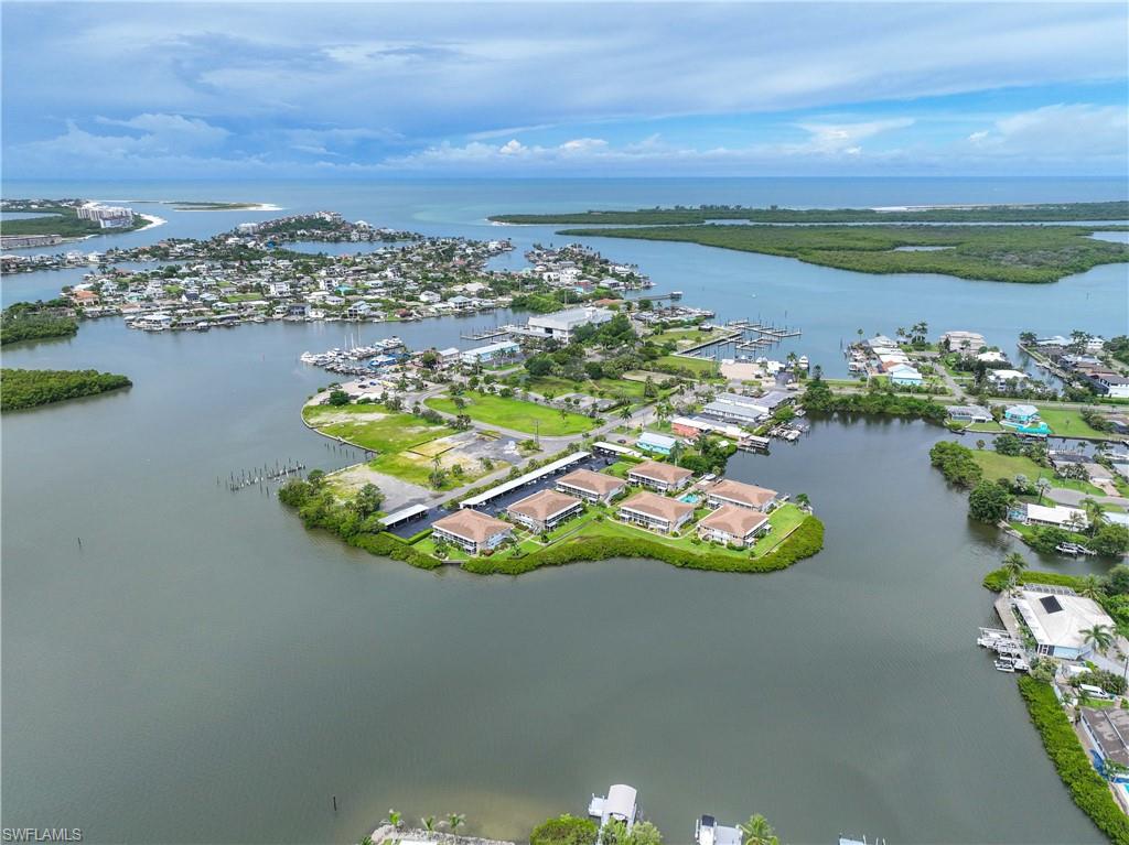 330 Kon Tiki Drive, Unit C7 Naples, FL 34113 - Photo 29 of 50 an aerial view of a house with a lake view