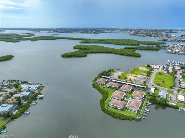 an aerial view of a houses with outdoor space and lake view