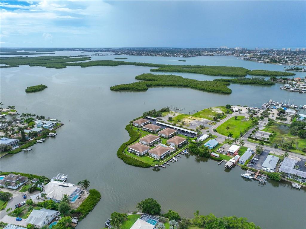 330 Kon Tiki Drive, Unit C7 Naples, FL 34113 - Photo 33 of 50 an aerial view of a house with a lake view