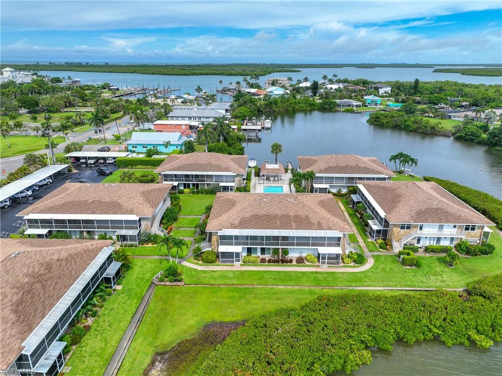 330 Kon Tiki Drive, Unit C7 Naples, FL 34113 - Photo 35 of 50 an aerial view of a house with outdoor space and lake view