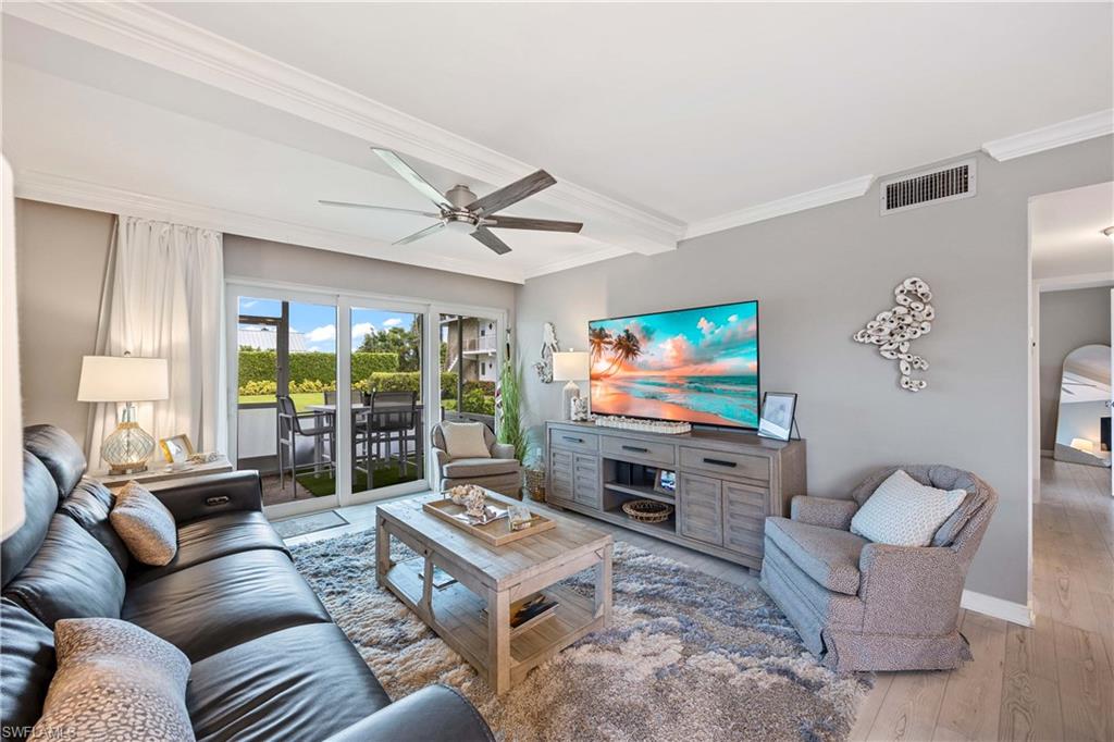 330 Kon Tiki Drive, Unit C7 Naples, FL 34113 - Photo 5 of 50 a living room with furniture and a flat screen tv