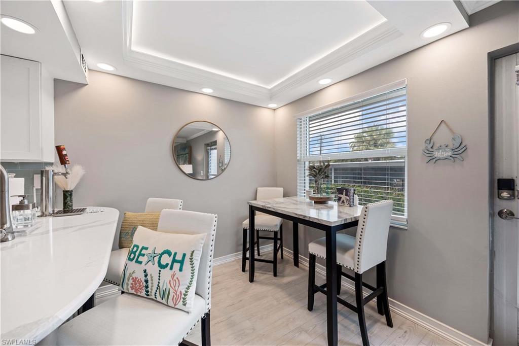 330 Kon Tiki Drive, Unit C7 Naples, FL 34113 - Photo 8 of 50 a bathroom with a sink a mirror and a window