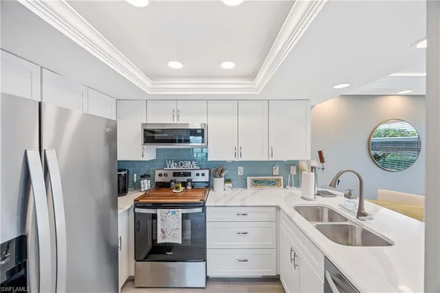 a kitchen with stainless steel appliances granite countertop a refrigerator sink and stove