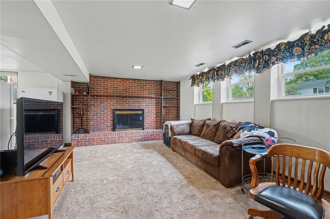 4919 Silver Arrow Drive Riverside, OH 45424 - Photo 35 of 57 This inviting living space features a cozy brick fireplace, perfect for relaxing evenings.