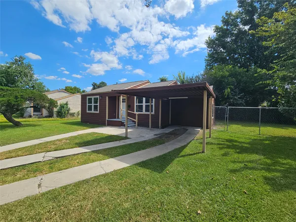 a view of a house with a yard and sitting area