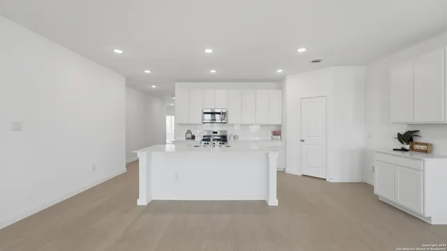 a view of kitchen with white cabinets