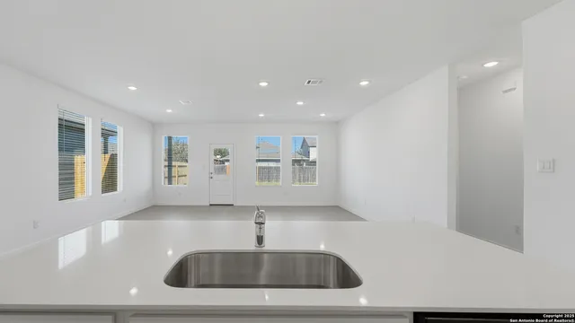 a kitchen with stainless steel appliances a sink and a refrigerator
