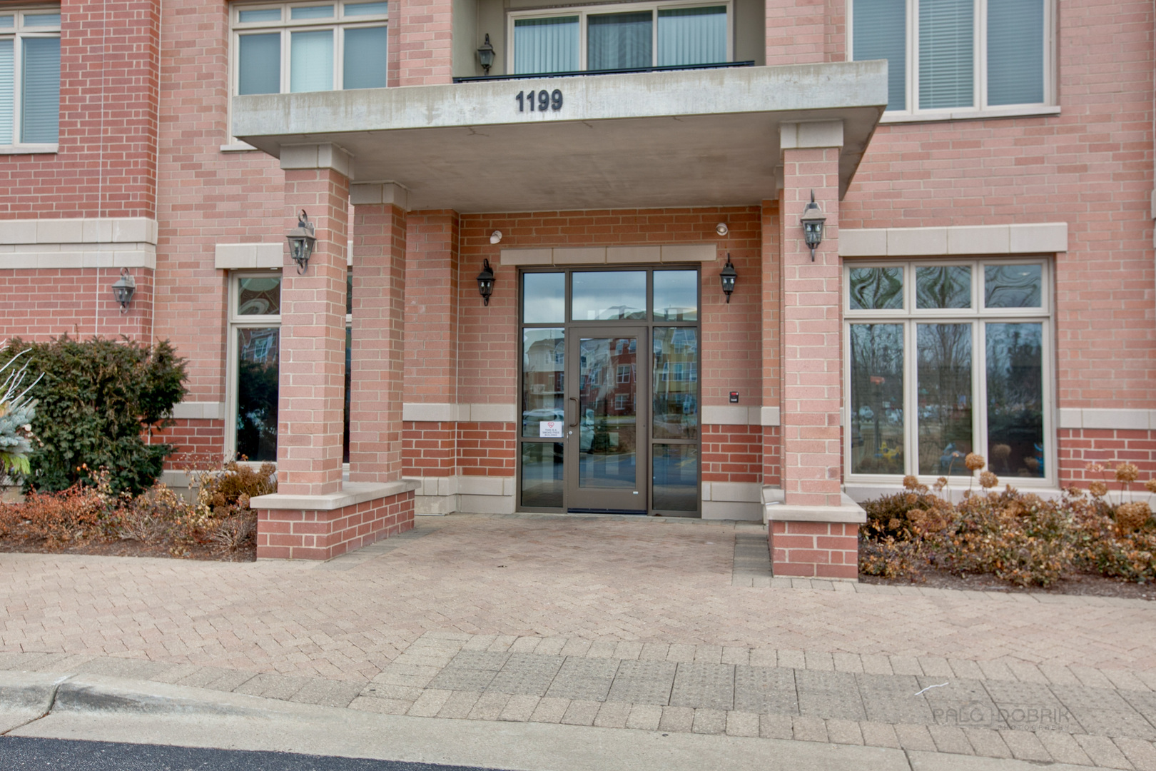 1199 East Port Clinton Road, Unit 405 Vernon Hills, IL 60061 - Photo 2 of 29 front view of a brick house with large windows