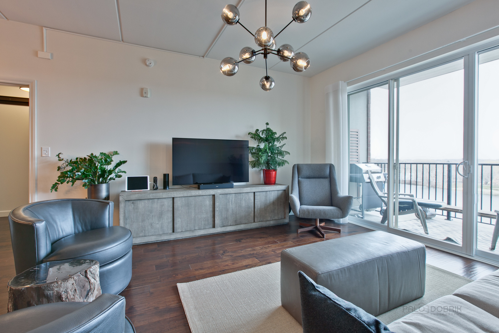 1199 East Port Clinton Road, Unit 405 Vernon Hills, IL 60061 - Photo 11 of 29 a living room with furniture and a flat screen tv