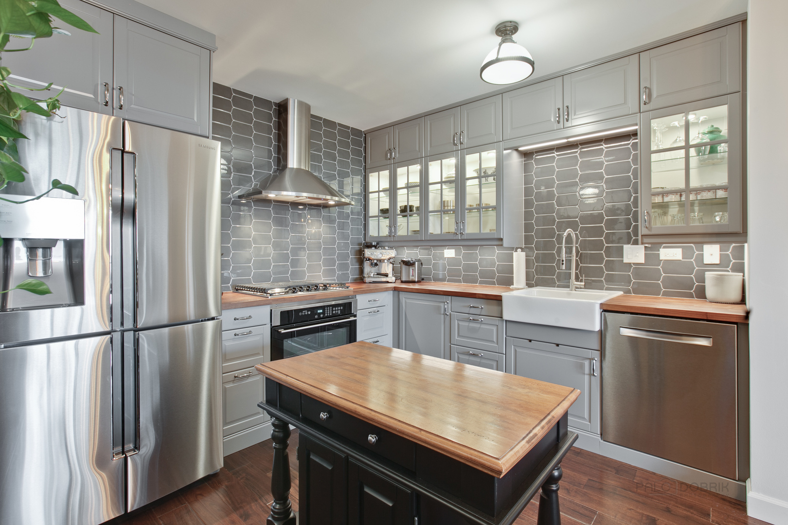 1199 East Port Clinton Road, Unit 405 Vernon Hills, IL 60061 - Photo 5 of 29 a kitchen with kitchen island a counter top space wooden floor and stainless steel appliances