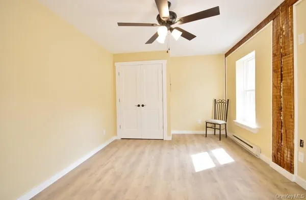a view of a livingroom with a ceiling fan and window