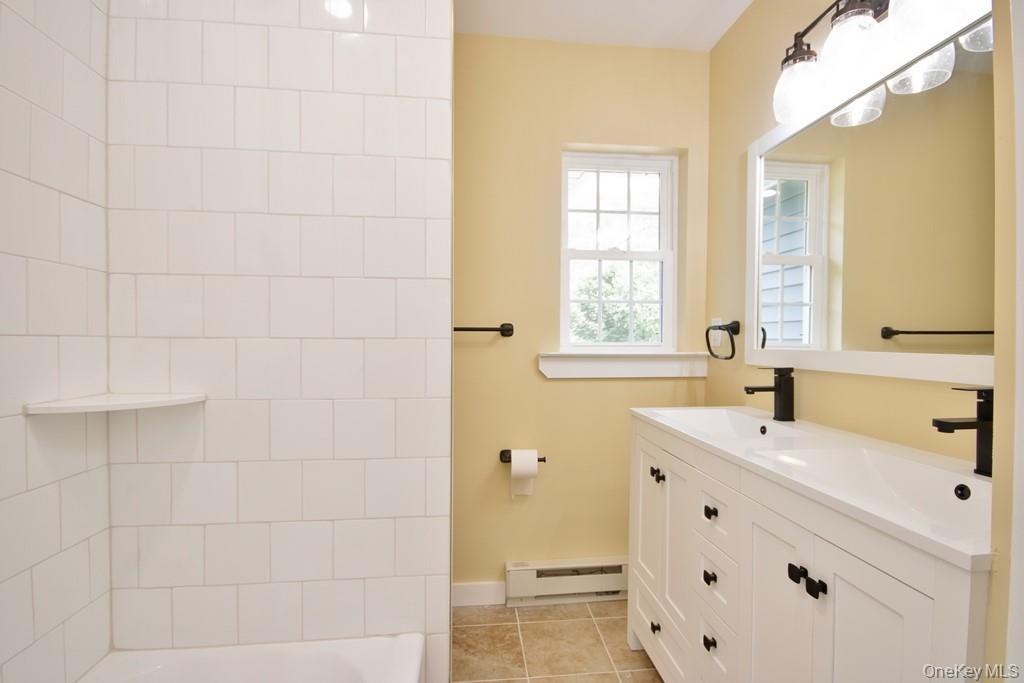 162 Rockland Road Roscoe, NY 12776 - Photo 17 of 36 a bathroom with a sink a mirror and a shower
