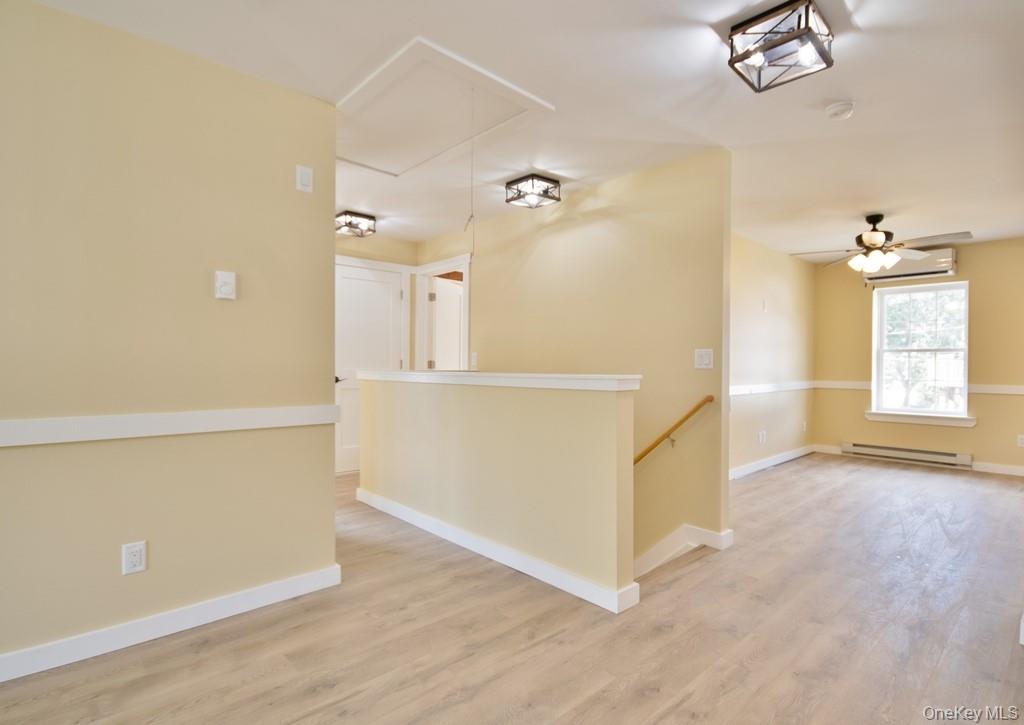 162 Rockland Road Roscoe, NY 12776 - Photo 19 of 36 an empty room with wooden floor and cabinet