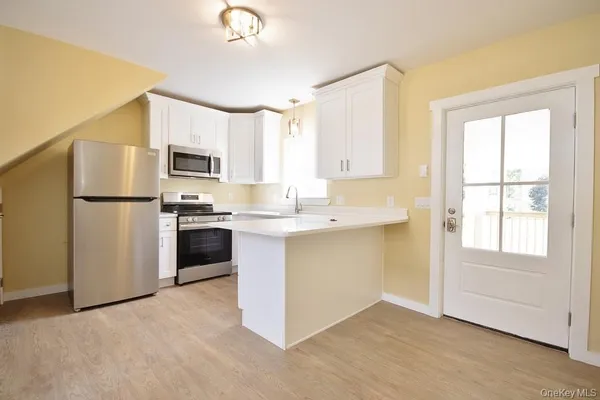 a kitchen with a sink stove and cabinets