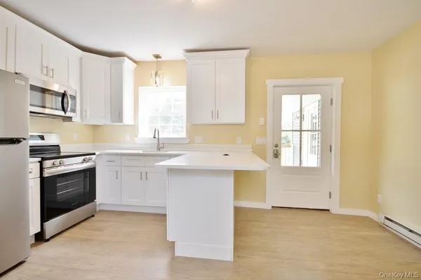 a kitchen with a sink cabinets and a window