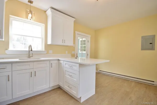 a bathroom with a toilet a sink a bath tub and a window
