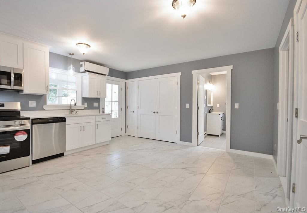 162 Rockland Road Roscoe, NY 12776 - Photo 28 of 36 a view of a kitchen with a sink and dishwasher a refrigerator with white cabinets