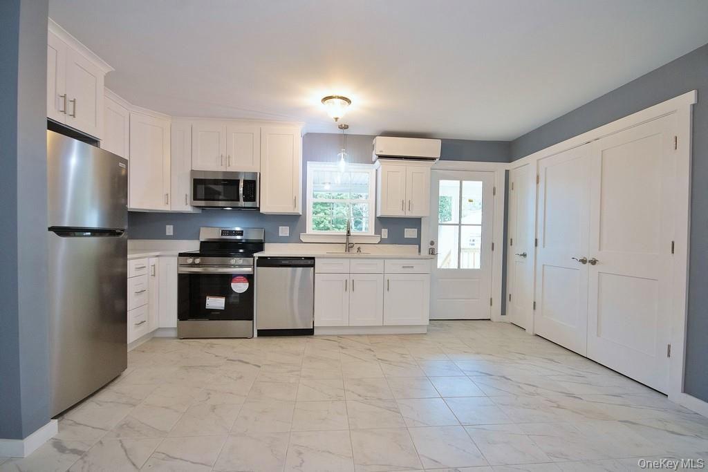 162 Rockland Road Roscoe, NY 12776 - Photo 29 of 36 a kitchen with kitchen island a refrigerator sink and stove