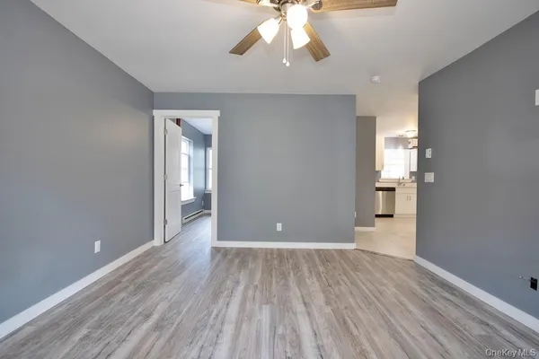 wooden floor in an empty room with a window