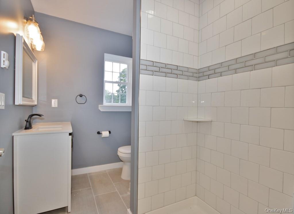 162 Rockland Road Roscoe, NY 12776 - Photo 34 of 36 a bathroom with a granite countertop shower a toilet and a sink