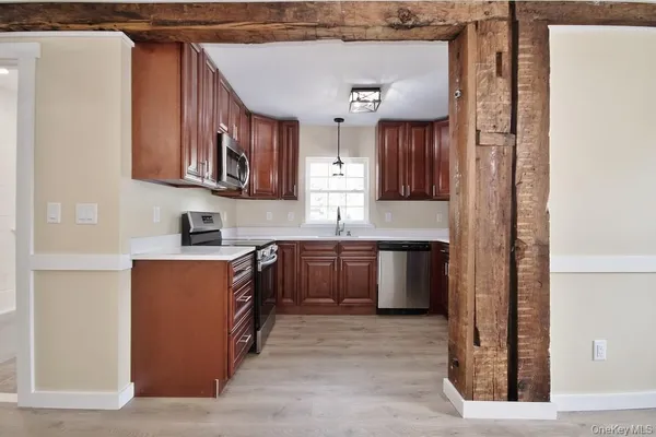 a kitchen with stainless steel appliances granite countertop a refrigerator and a stove top oven