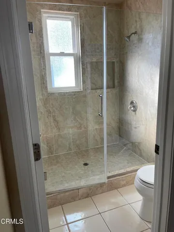 a bathroom with a shower and toilet