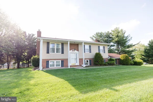 a front view of house with yard and green space