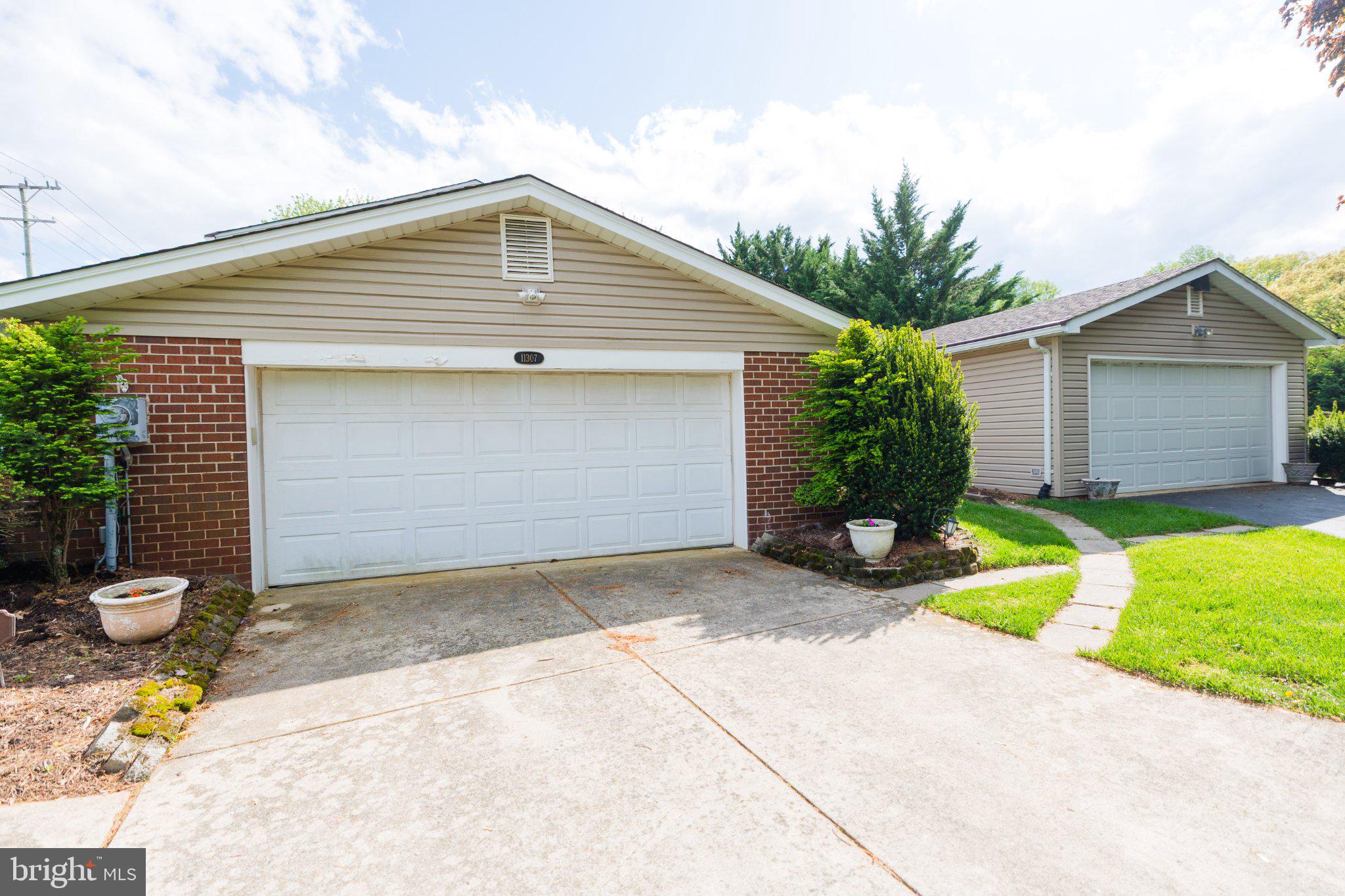 11307 Treeview Lane Monrovia, MD 21770 - Photo 103 of 116 Charming dual garage with lush greenery.