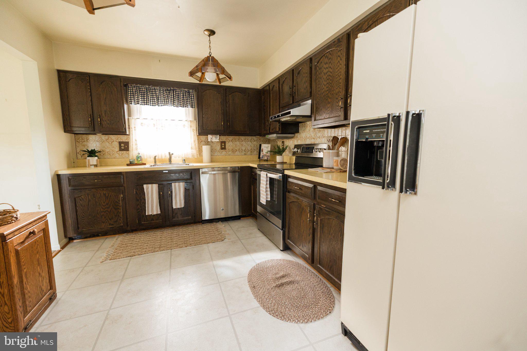 11307 Treeview Lane Monrovia, MD 21770 - Photo 13 of 63 a kitchen with stainless steel appliances granite countertop a sink stove and refrigerator