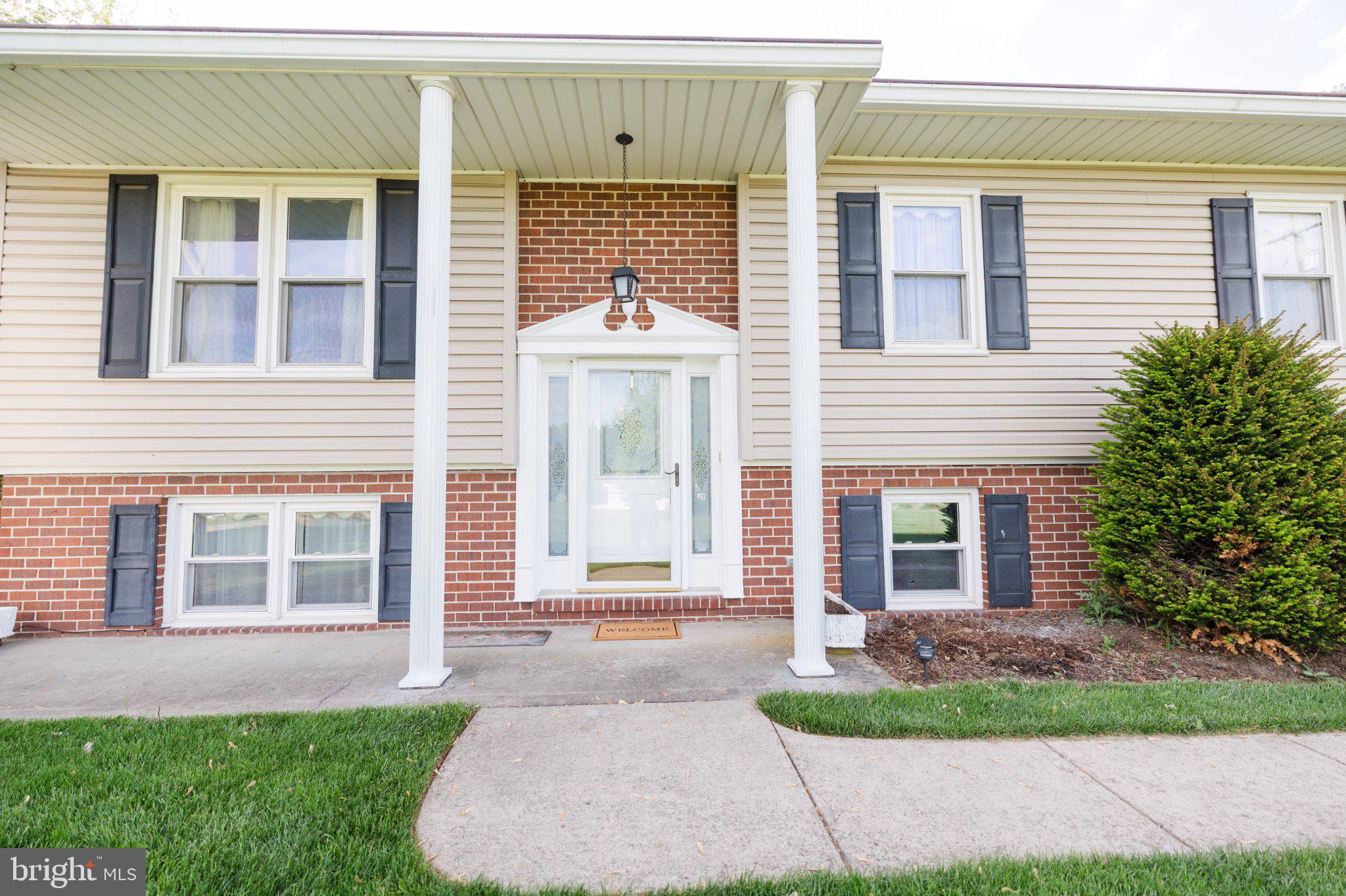 11307 Treeview Lane Monrovia, MD 21770 - Photo 48 of 63 a front view of a house with a garden
