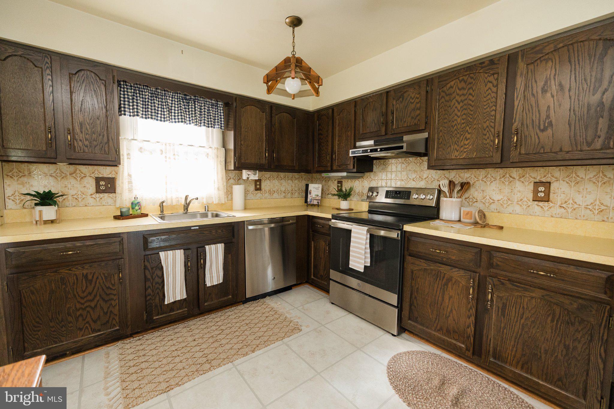 11307 Treeview Lane Monrovia, MD 21770 - Photo 7 of 63 a kitchen with cabinets a sink stainless steel appliances and window