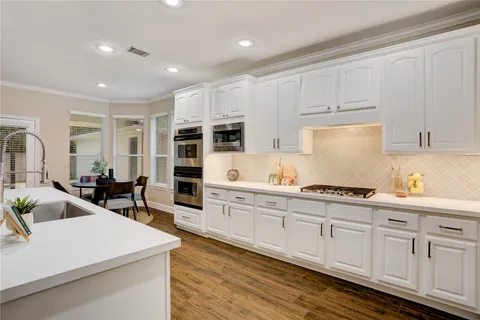 a kitchen with sink cabinets and stove