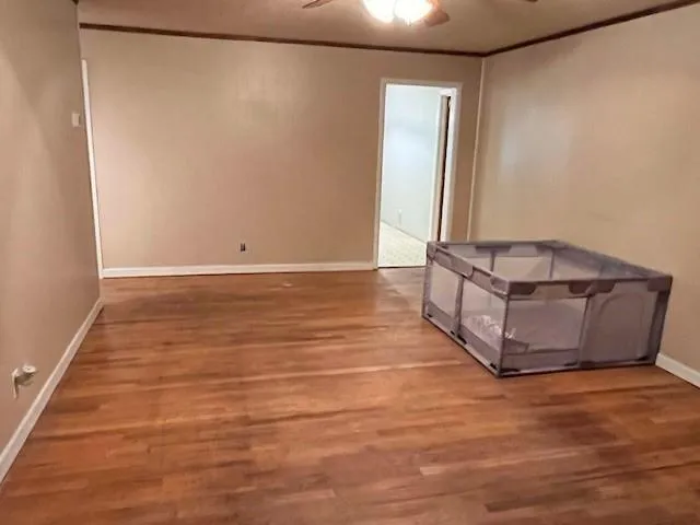 a room with an empty room and wooden floor