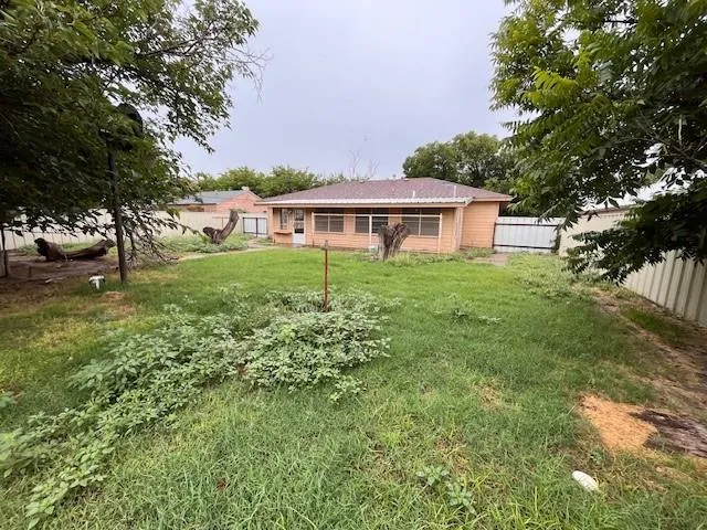 a big yard with lots of green space and trees