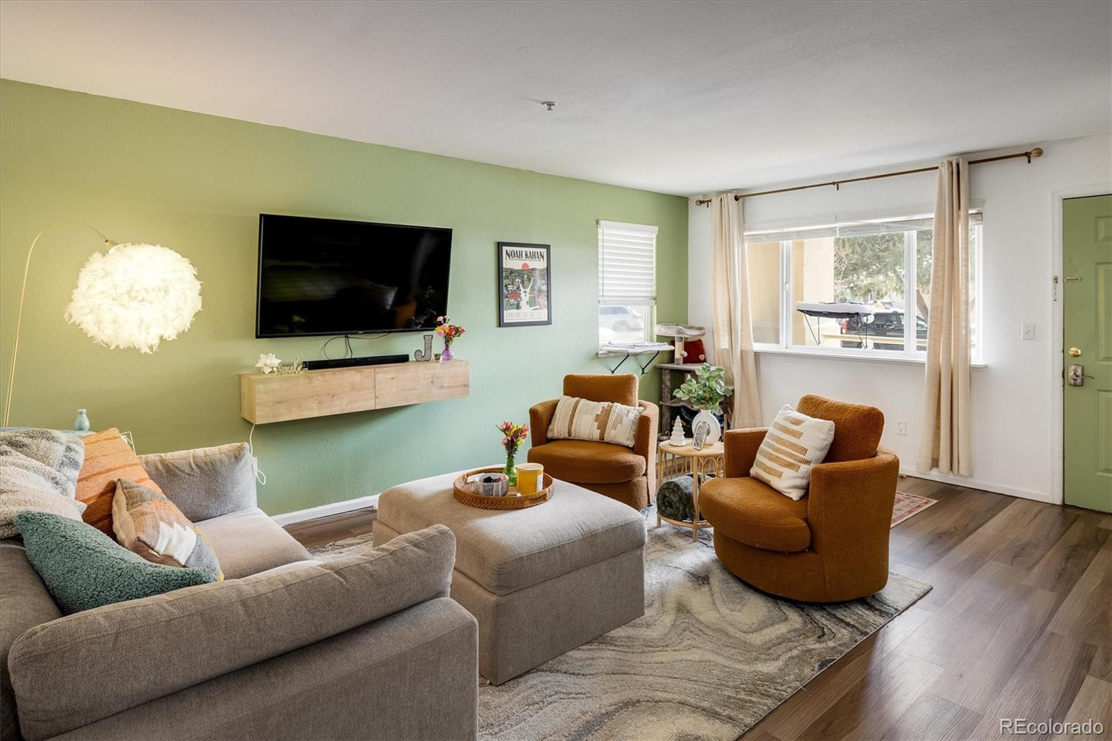 935 Broadway, Unit 104 Boulder, CO 80302 - Photo 2 of 30 a living room with furniture and a flat screen tv