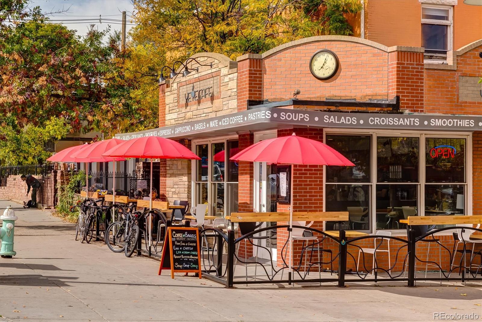 935 Broadway, Unit 104 Boulder, CO 80302 - Photo 26 of 30 an outdoor space with a table and chairs under an umbrella