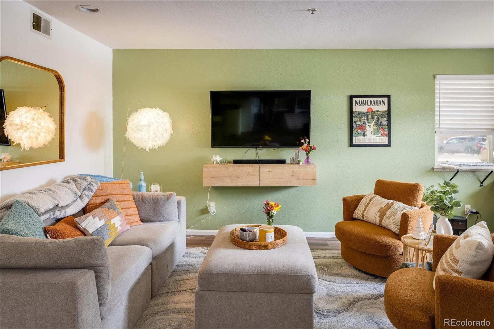 935 Broadway, Unit 104 Boulder, CO 80302 - Photo 3 of 30 a living room with furniture and a flat screen tv