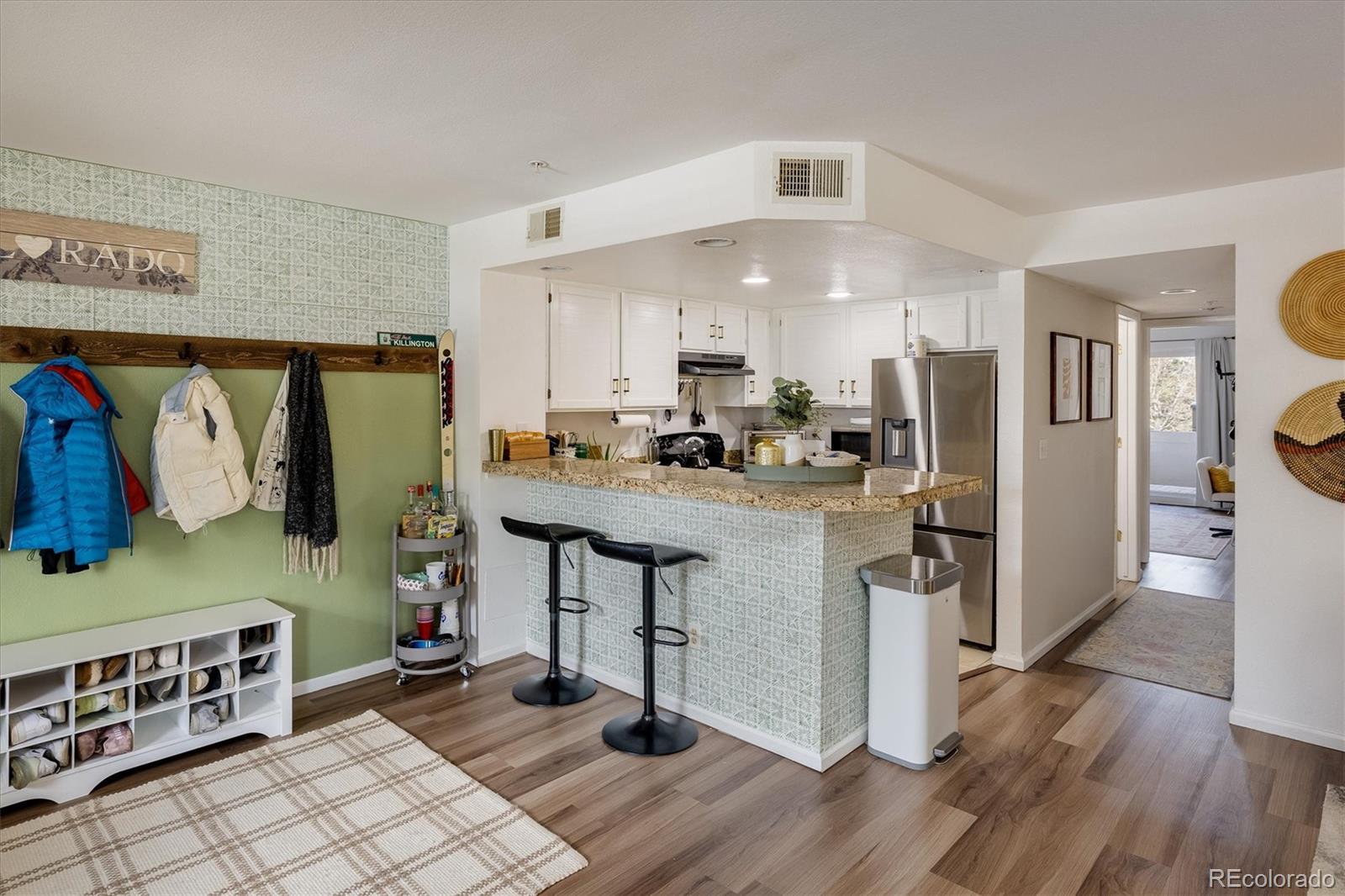935 Broadway, Unit 104 Boulder, CO 80302 - Photo 6 of 30 a kitchen with stainless steel appliances a refrigerator and a stove top oven