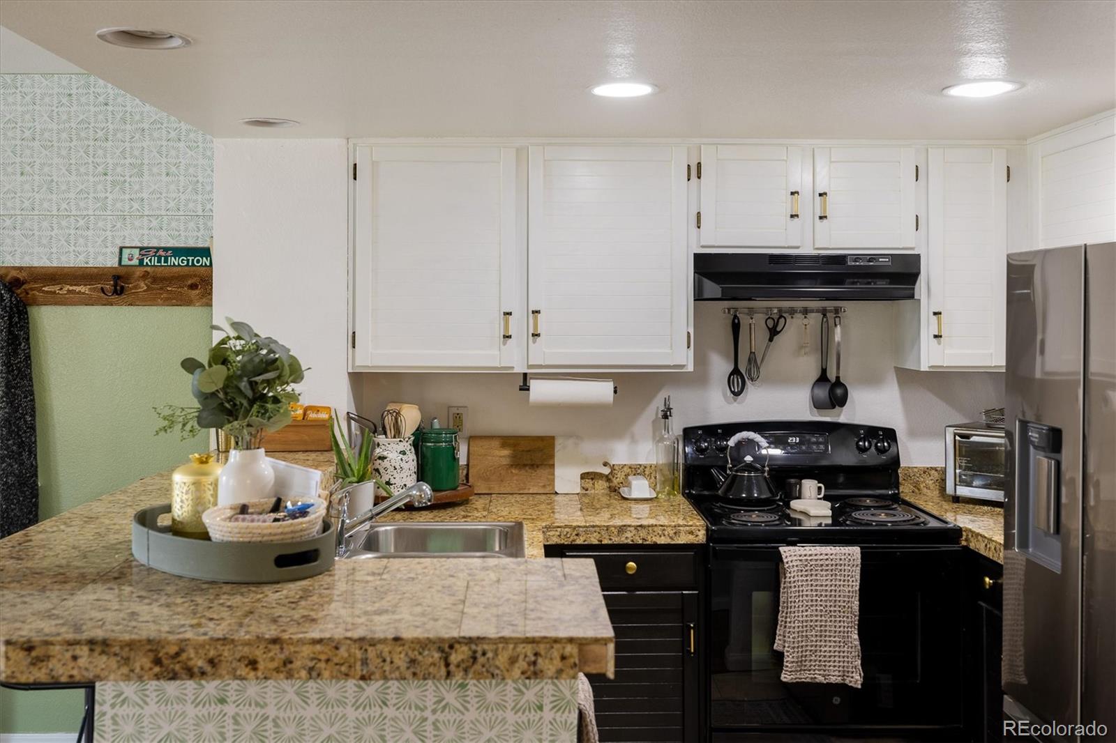 935 Broadway, Unit 104 Boulder, CO 80302 - Photo 7 of 30 a kitchen with a stove and cabinets