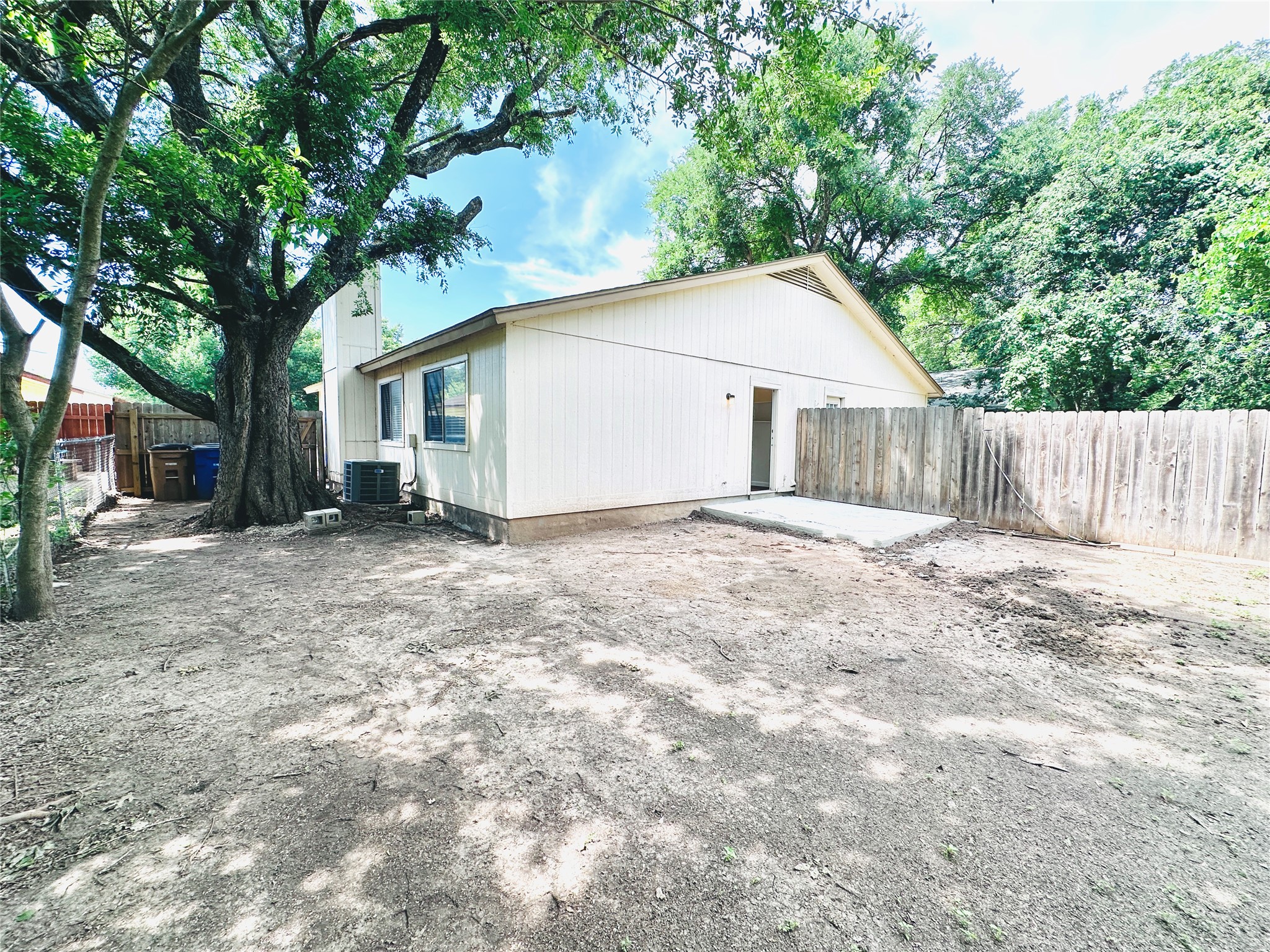12505 Turtle Rock Road, Unit A Austin, TX 78729 - Photo 36 of 38 A spacious backyard awaits, offering a private outdoor area for relaxation and potential landscaping.
