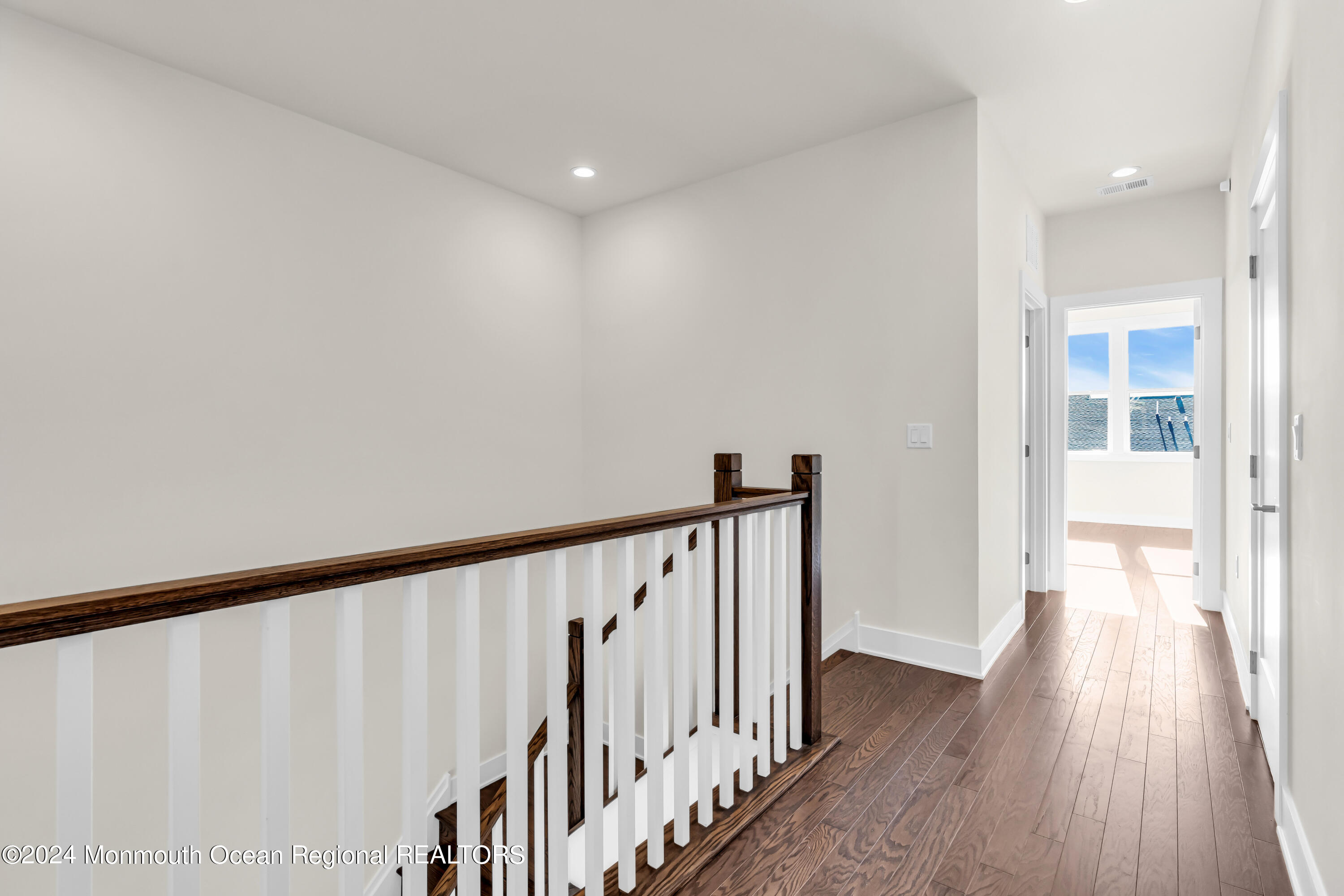 6 Augustus Drive Middletown, NJ 07748 - Photo 12 of 28 a view of a hallway with wooden floor and staircase
