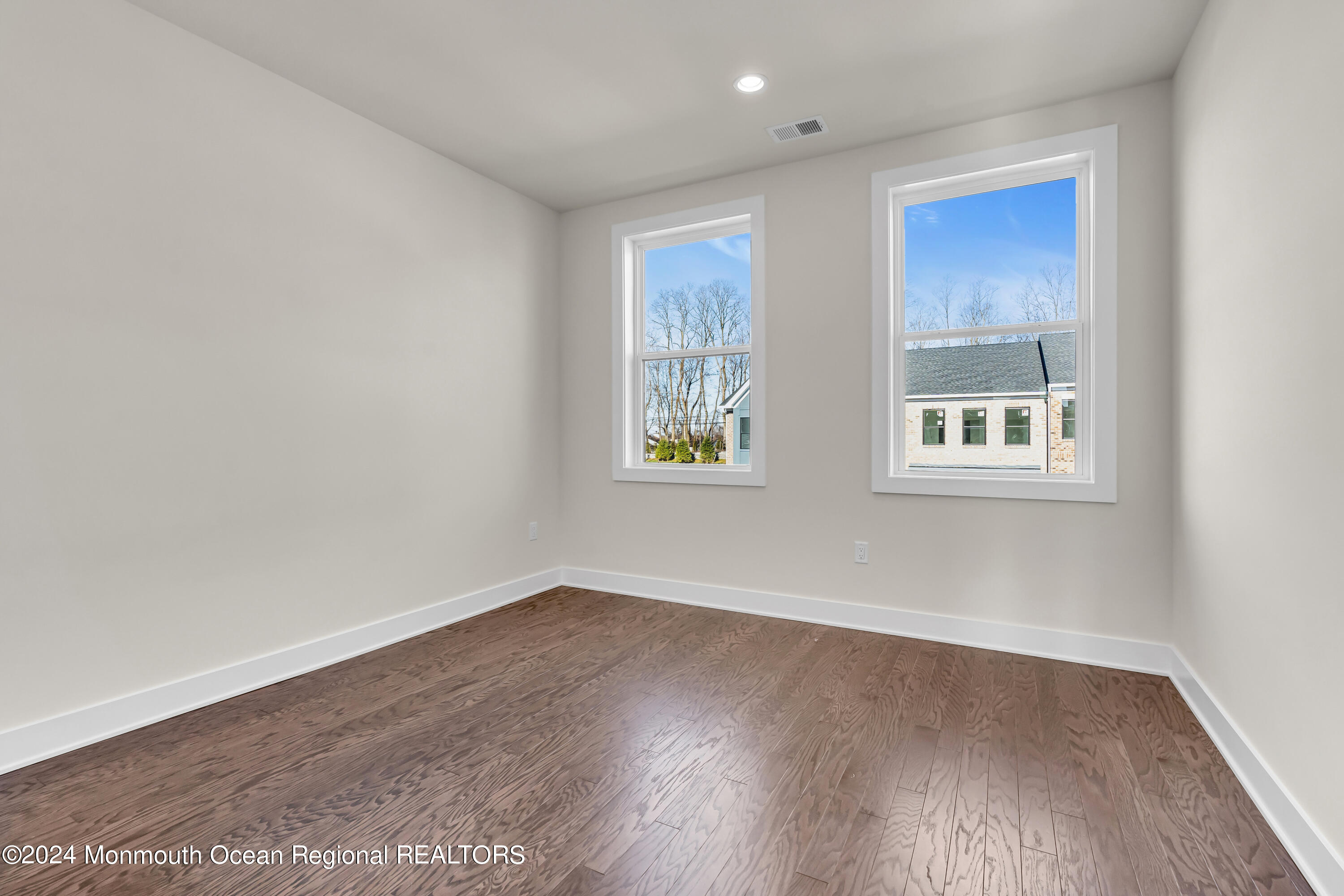 6 Augustus Drive Middletown, NJ 07748 - Photo 16 of 28 an empty room with wooden floor and windows
