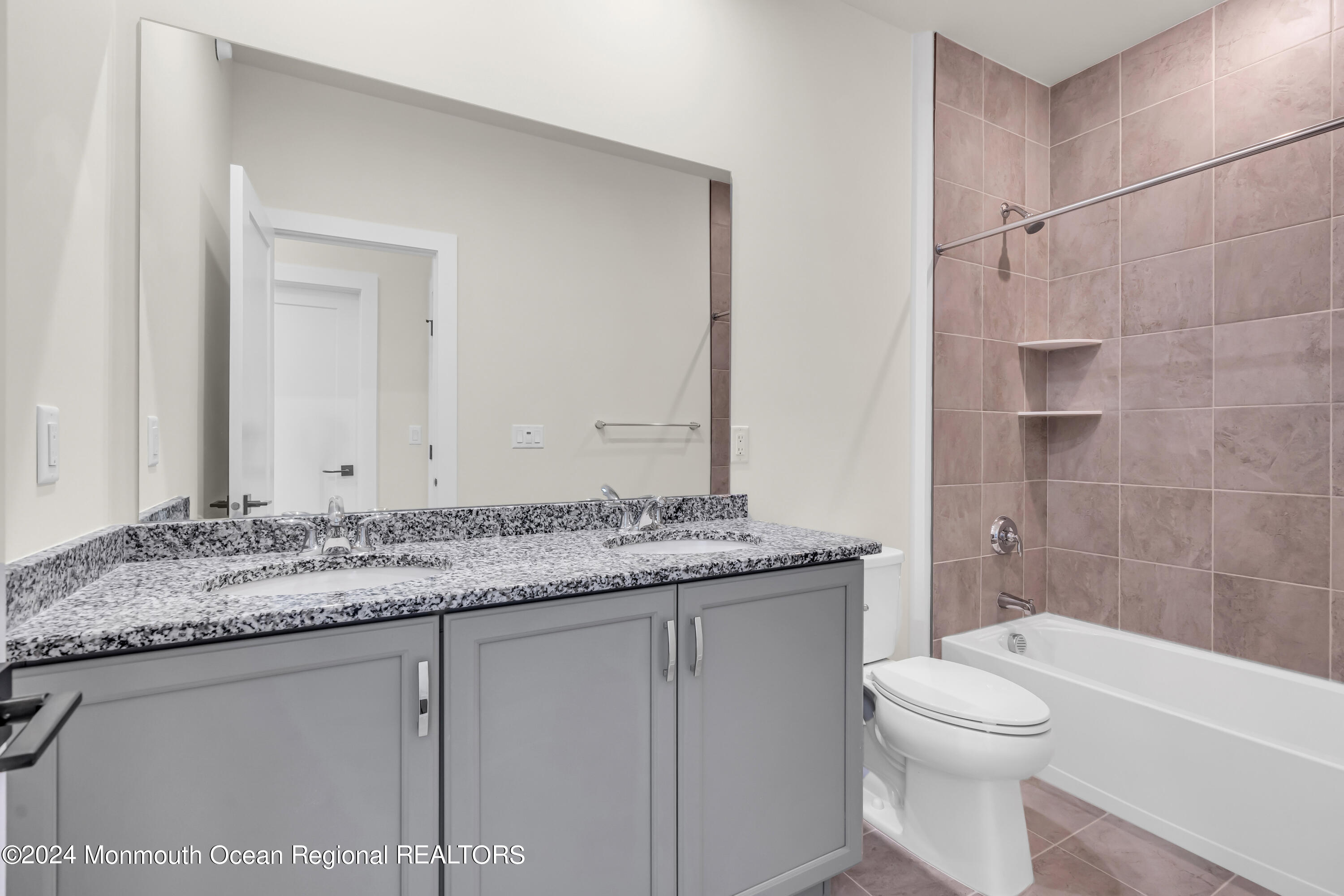 6 Augustus Drive Middletown, NJ 07748 - Photo 18 of 28 a bathroom with a granite countertop sink a toilet and bathtub