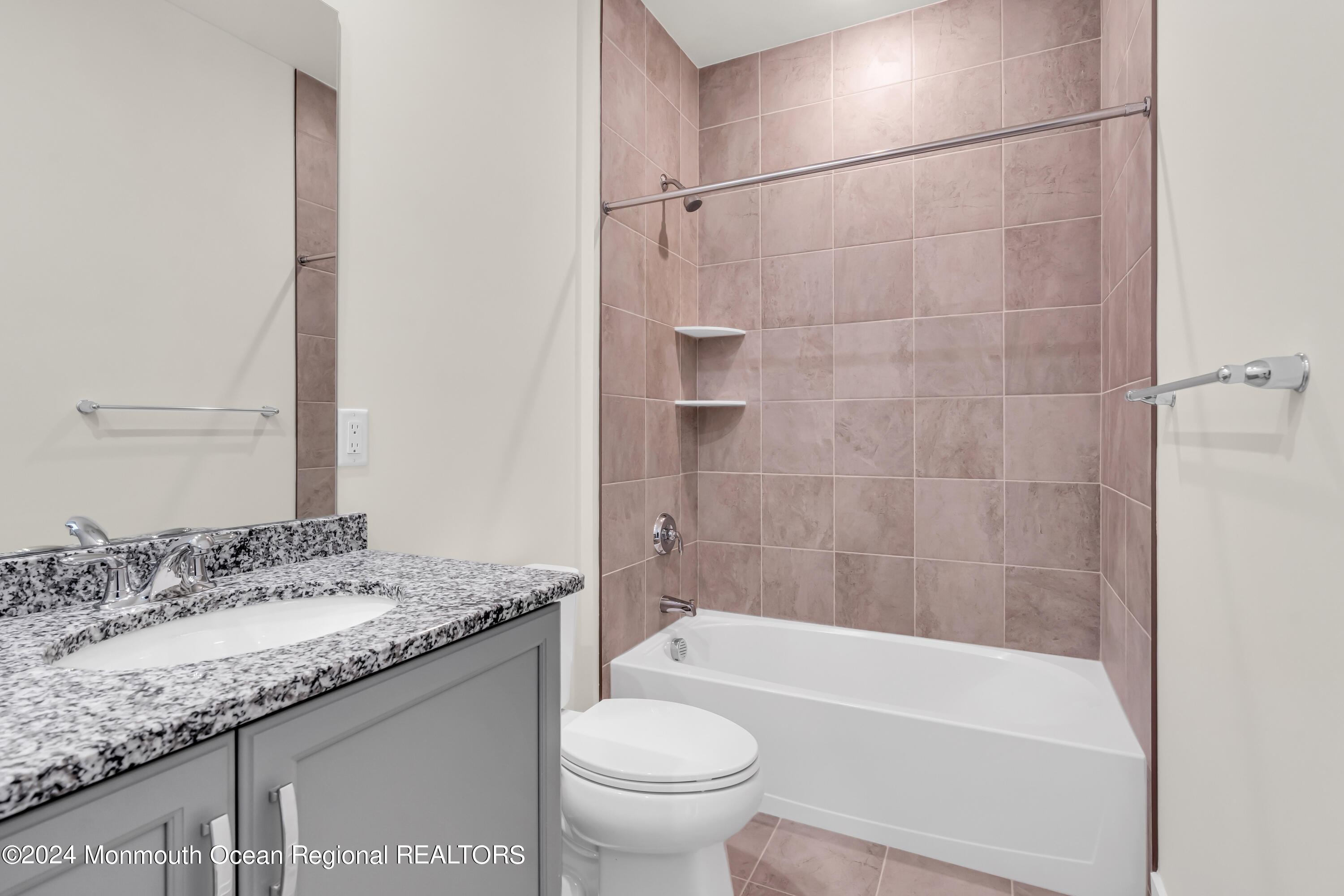 6 Augustus Drive Middletown, NJ 07748 - Photo 19 of 28 a bathroom with a granite countertop sink a toilet and bathtub