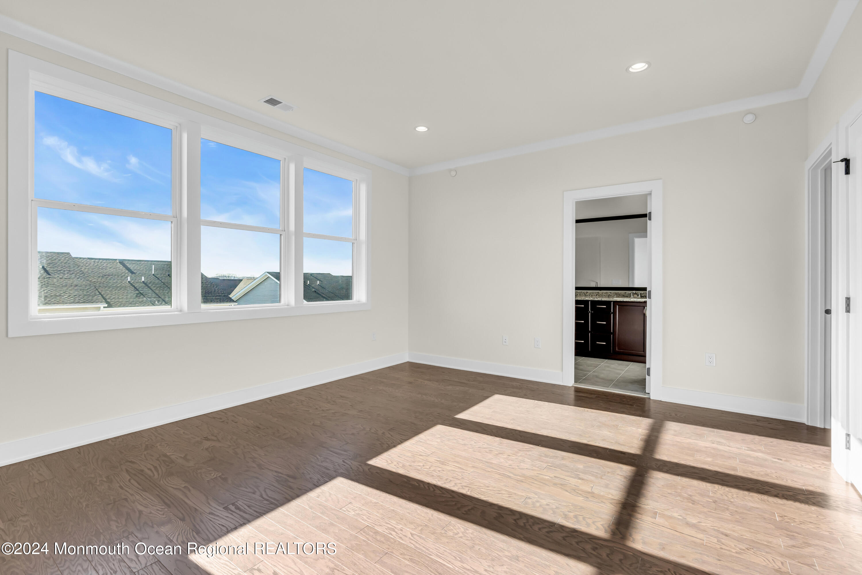 6 Augustus Drive Middletown, NJ 07748 - Photo 22 of 28 a view of an empty room with a window and wooden floor