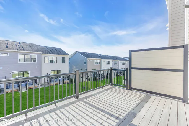 a view of a house with a wooden deck