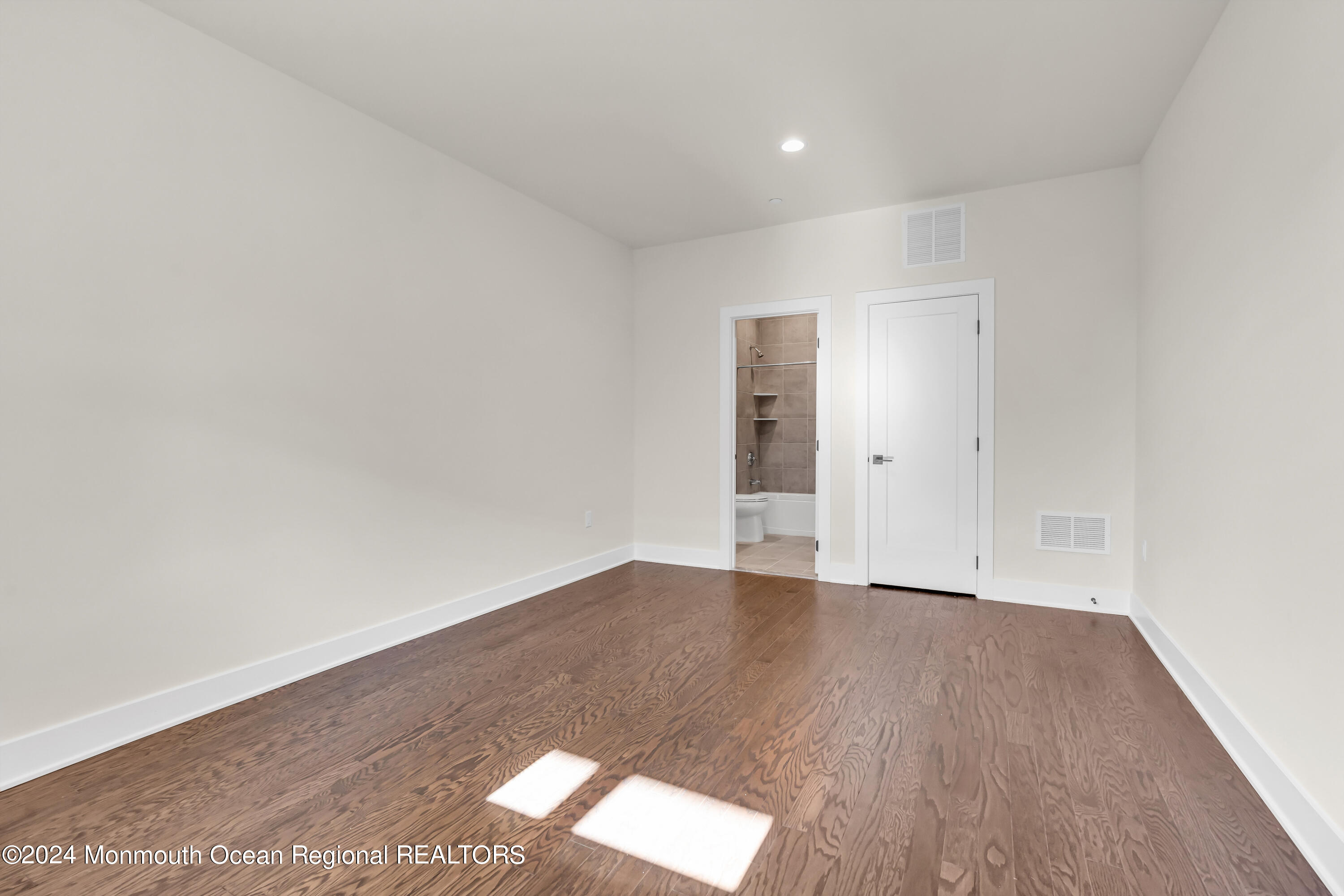 6 Augustus Drive Middletown, NJ 07748 - Photo 9 of 28 an empty room with wooden floor