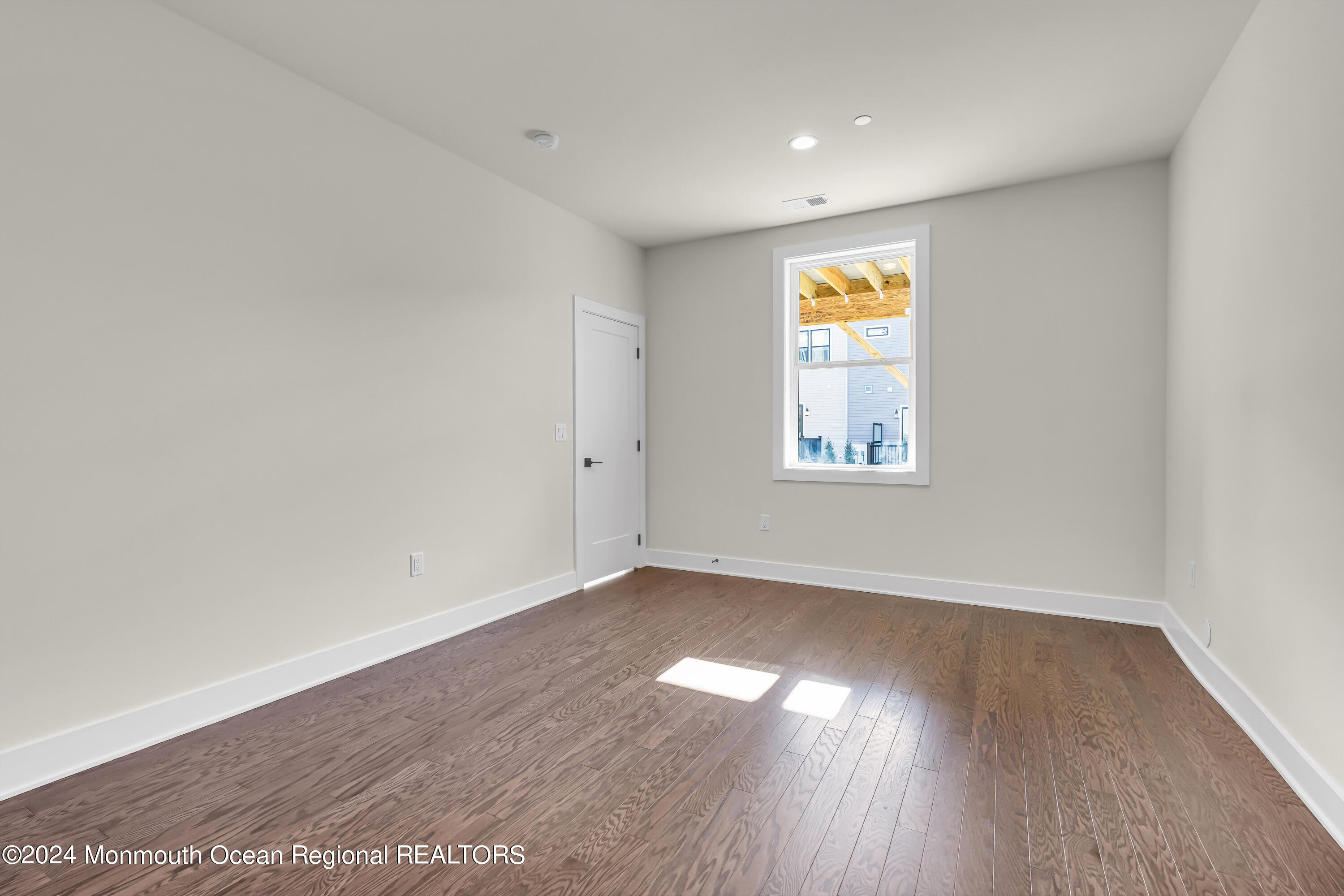 6 Augustus Drive Middletown, NJ 07748 - Photo 10 of 28 an empty room with wooden floor and windows