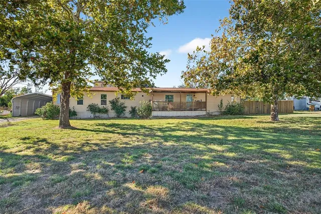 a house view with swimming pool in front of it