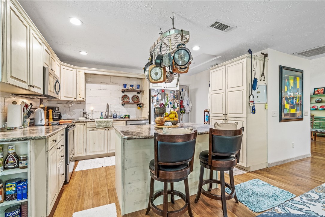 5313 Palm Drive Fort Pierce, FL 34982 - Photo 13 of 36 a view of a dining room with furniture a kitchen and chandelier